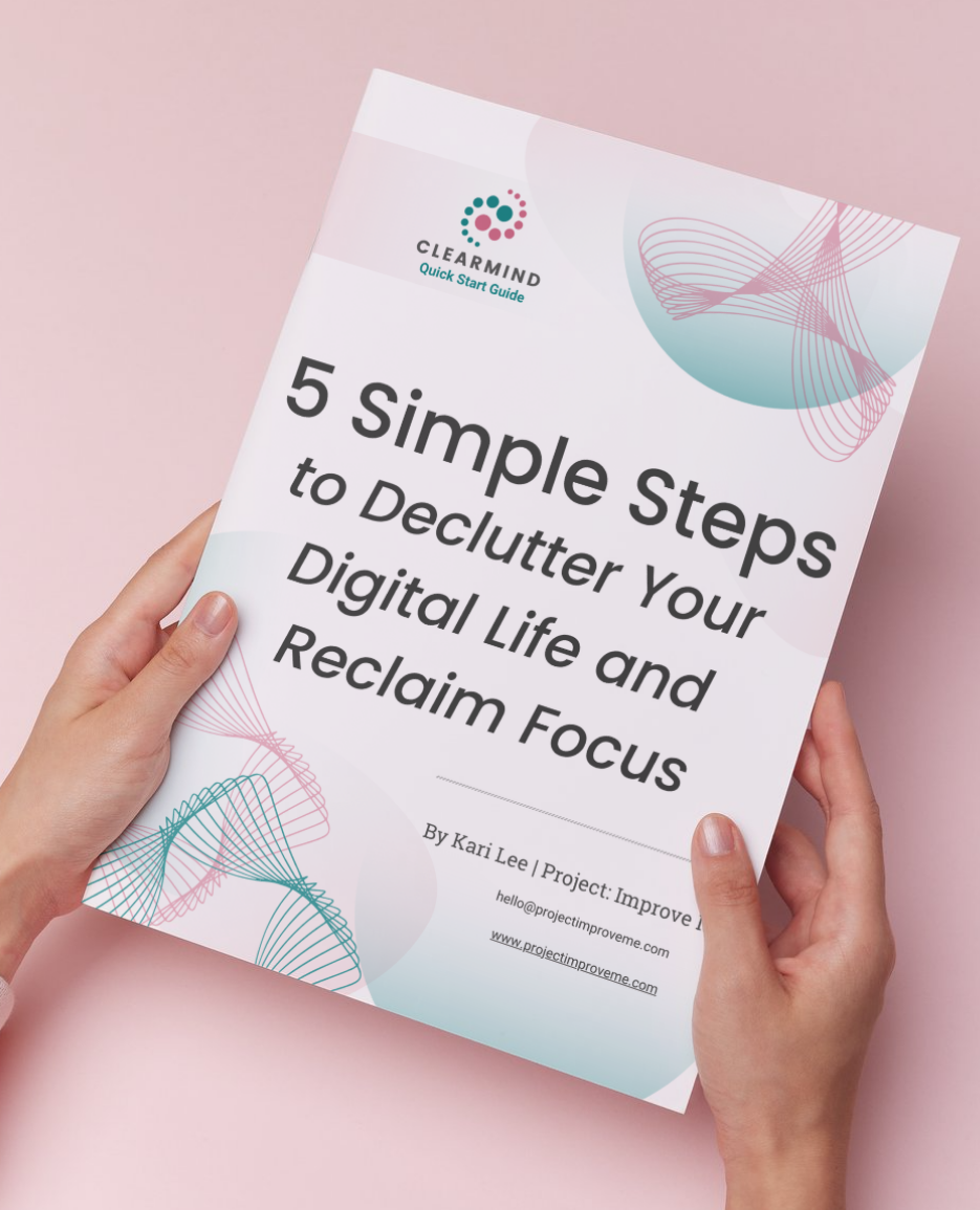A woman in midlife gently holds a booklet, 5 Simple Steps to Declutter Your Digital Life, on a pink background offering support.