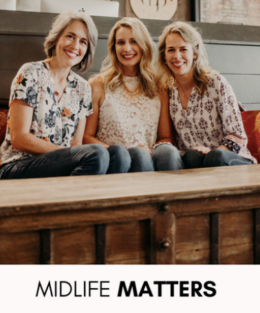 Three women sit together on a cozy couch, smiling warmly. Text below: Midlife Matters—uplifting stories for women over 40.